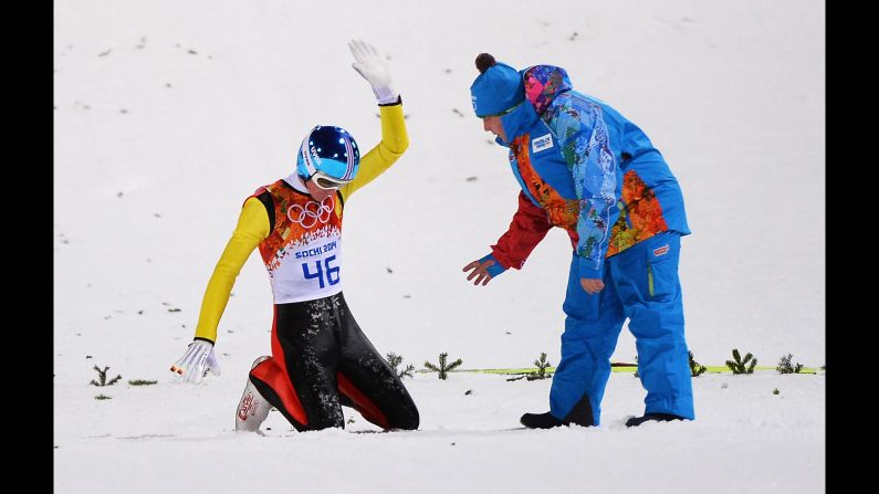 Severin Freund of Germany acknowledges the crowd after crashing during the men's normal hill ski jump event on February 9.