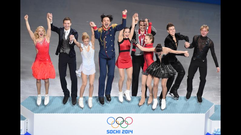 The Russian figure skating team celebrates on the podium after winning the gold medal February 9.
