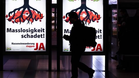 A man walks past posters from the right-wing populist Swiss People's Party ahead of Sunday's referendum