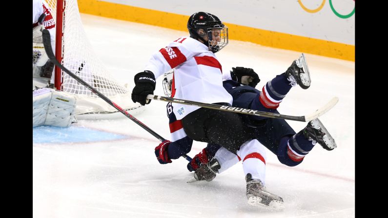 Swiss hockey player Angela Frautschi, left, clashes with Kendall Coyne of the United States during their game February 10.