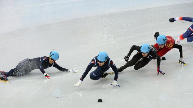 South Korea's Sin Da-Woon, left, falls as he competes in the 1,500-meter short track semifinals on February 10.