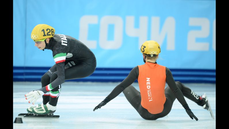 The Netherlands' Sanne van Kerkhof, right, falls next to Italy's Lucia Peretti as they compete in the 3,000-meter short track relay February 10.