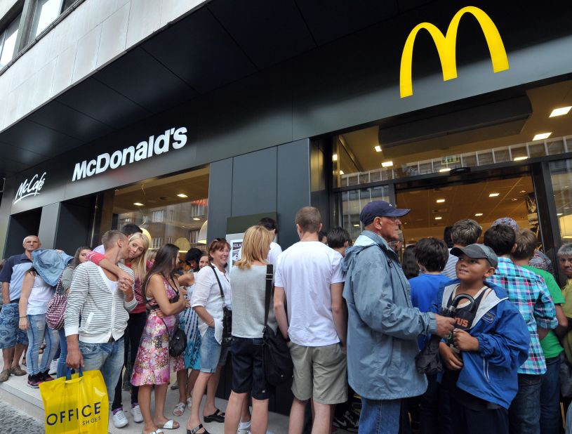 People wait in line at the first Bosnian McDonald's restaurant in the capital, Sarajevo, which opened in 2011 after a four year battle with local shop and cafe owners, and the country's government.