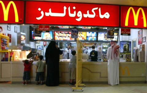 A segregation board separates men and women at a McDonald's in Riyadh in 2004. Restaurants in Saudi Arabia are divided into a family section and a section for men.