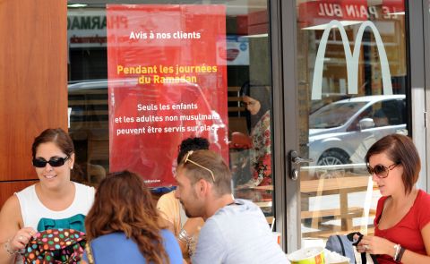 Non-Muslims eat lunch on the terrace of a McDonald's in Rabat, Morocco. Muslim adults are forbidden from being served at the restaurant during the day during fasting for the holy month of Ramadan.
