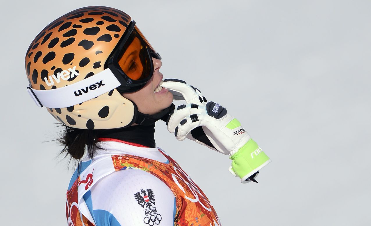 Anna Fenninger of Austria holds one of her gloves after her downhill run in the super-combined event.