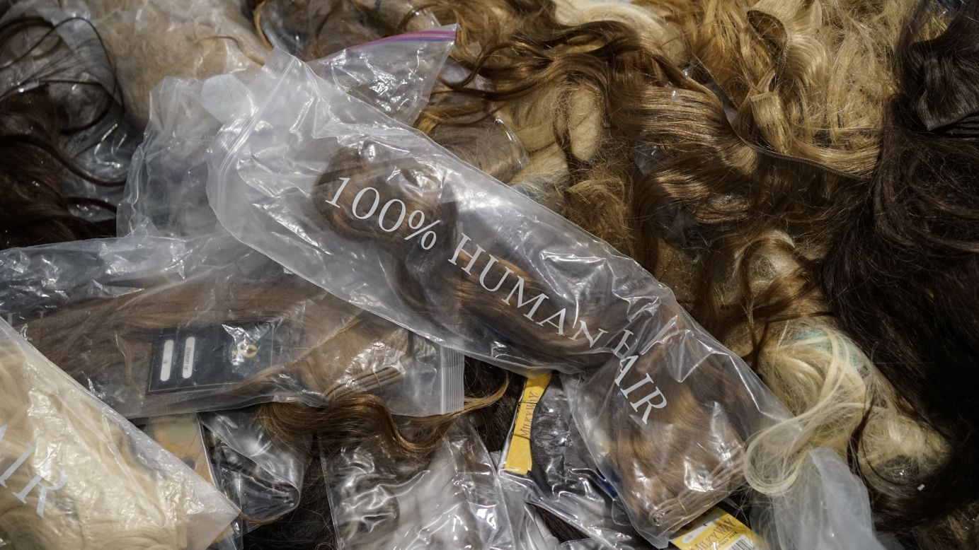 "Give me a head with hair, long beautiful hair." Hair extensions of every color are seen backstage at Custo Barcelona's show.