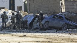 U.S. soldiers and Afghan security forces search the site of a suicide bombing in the Afghan capital Kabul, Afghanistan, on February 10, 2014.