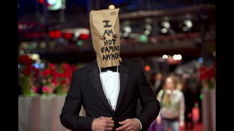 Although LaBeouf didn't stay for "Nymphomaniac's" media event, he did show up for the premiere wearing one eye-catching accessory: a paper bag over his head bearing his favorite phrase, "I AM NOT FAMOUS ANYMORE," scrawled in black marker. 