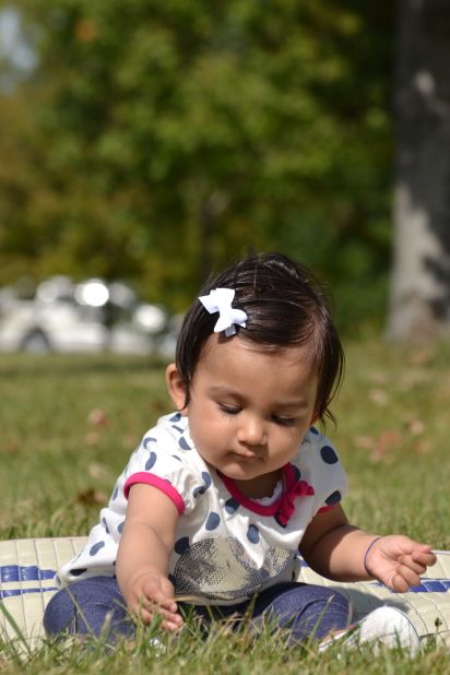 "Hey Mom ... I am picking some fresh greens for salad today" -- Rhea Purohit, age 9 months, forages in New Jersey's Liberty State Park.