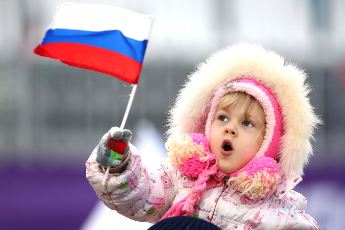 A young child waves a Russian flag on February 10.