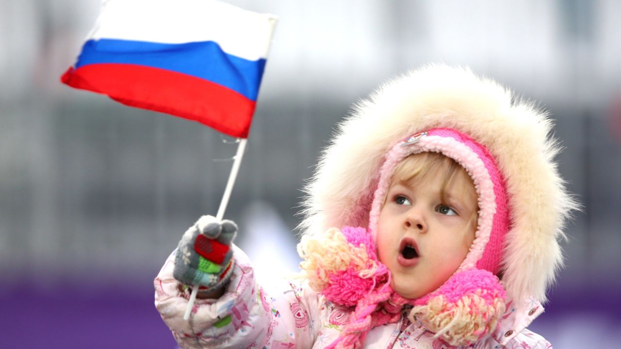 A young child waves a Russian flag during the Olympics on February 10.
