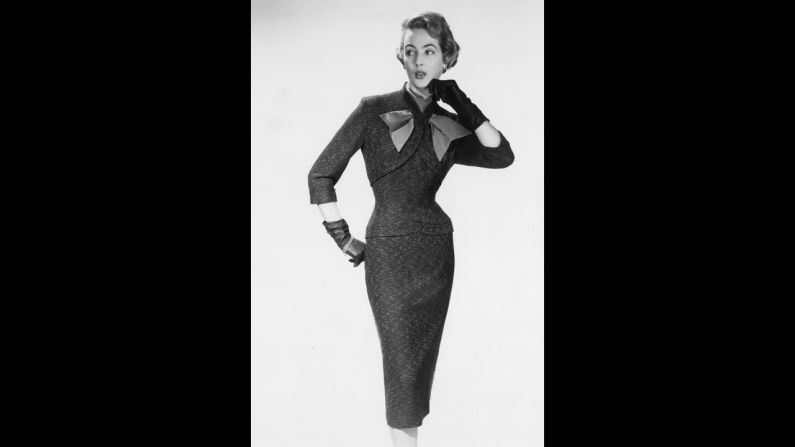 The bolero-style bodice and fitted skirt on this 1950s dress emphasizes the waist of a feminine figure.  