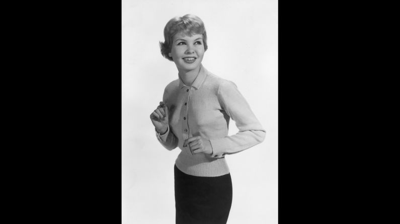 A fitted waist and collar are the noticeably ladylike elements of this cardigan, circa 1957.