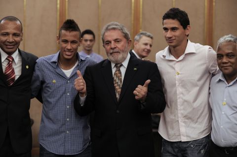 Neymar Senior, pictured on the left, represents his son, seen here alongside former Brazil President Luiz Inacio Lula da Silva as well as his onetime playing partner at Santos, Paulo Henrique Ganso.