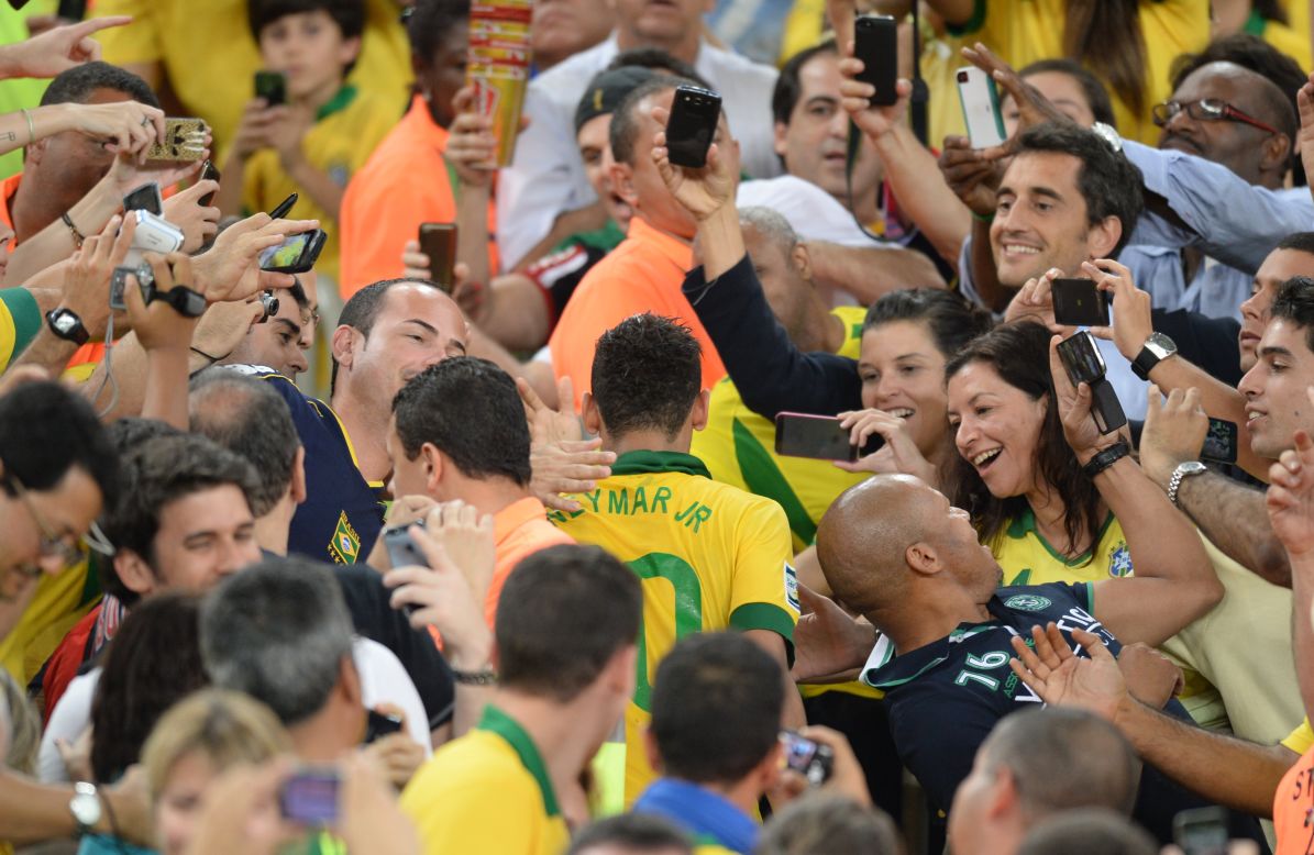 Neymar is mobbed by members of the public in Rio's Maracana after his starring role -- voted best player in addition to being top goalscorer -- during Brazil's Confederations Cup triumph on home soil last year. 