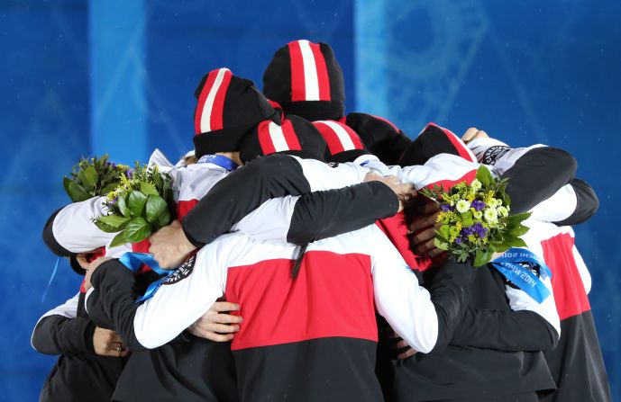 Canada's figure skating team celebrates winning silver on February 10.