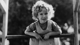 circa 1933: Shirley Temple (1928 - ) the American child star at five years of age, standing on her climbing frame at home. (Photo by Hulton Archive/Getty Images)