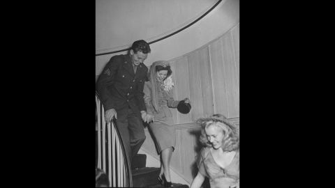 Temple and John Agar walk down a staircase after their wedding in 1945. The couple divorced in 1950.