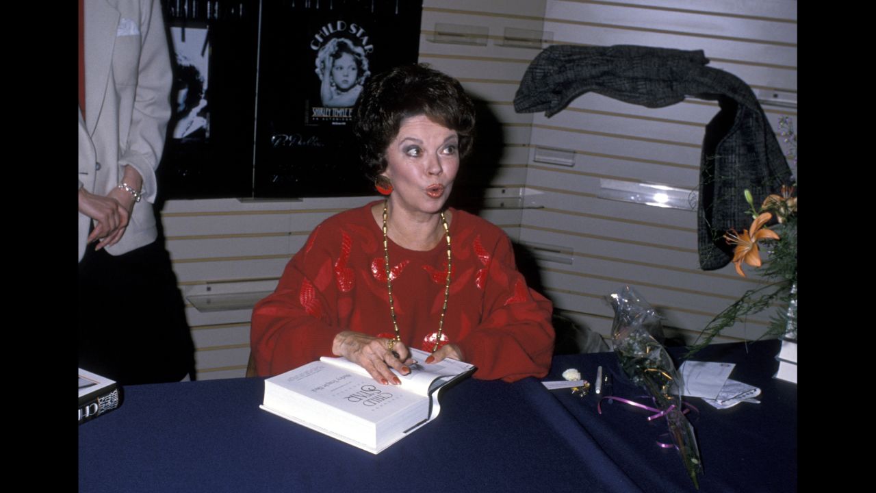 Temple Black signs copies of her book "Child Star" in 1988.