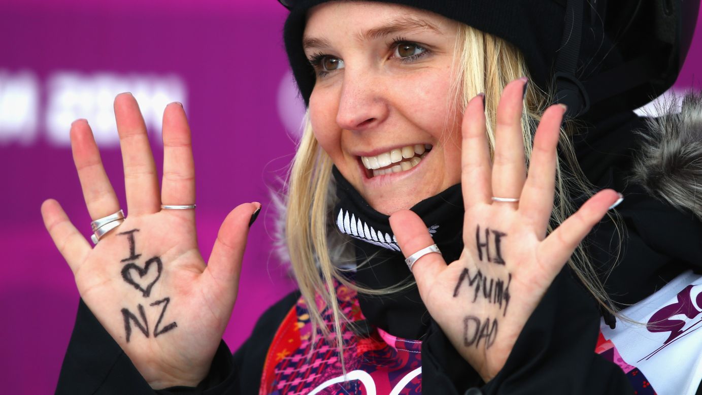 Skier Anna Willcox-Silfverberg of New Zealand holds up messages written on her hands during the slopestyle qualification.