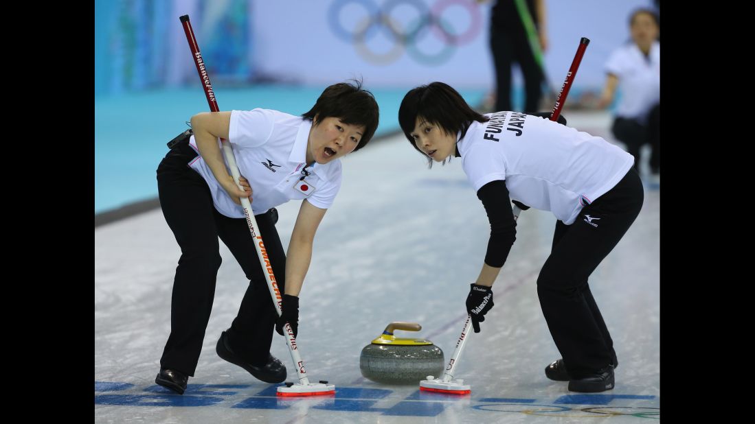 Michiko Tomabechi and Yumie Funayama of Japan sweep the ice during their curling match against South Korea on February 11.