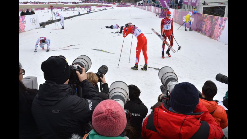 Photographers gather at the finish line February 11 during a qualification race for the men's cross-country sprint.