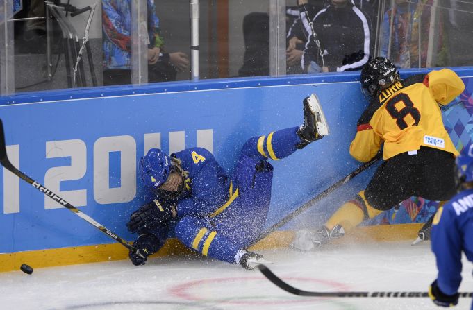 Sweden's Jenni Asserholt falls after missing a hit on Germany's Julia Zorn during their ice hockey match on February 11.