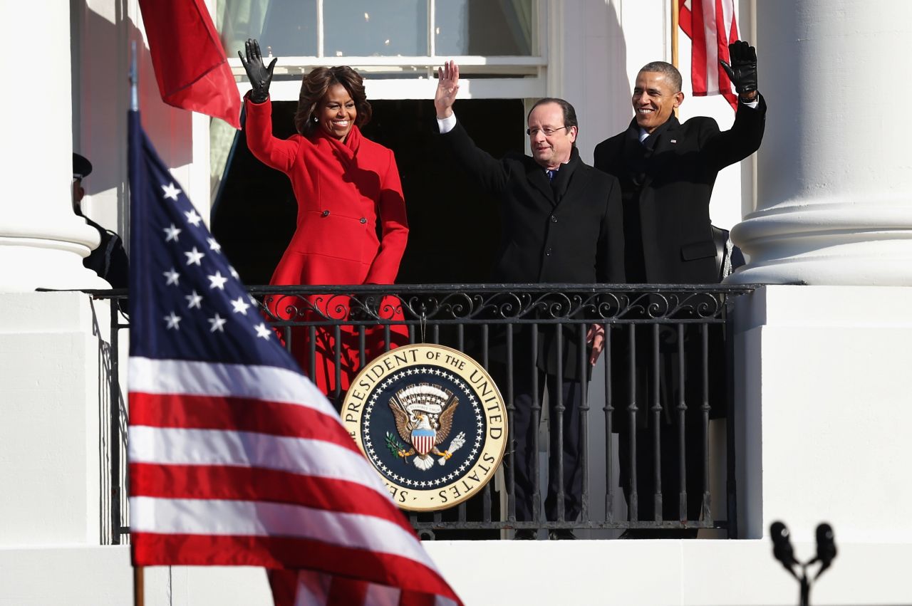 Obama, Hollande and first lady Michelle Obama wave from a White House balcony on February 11.
