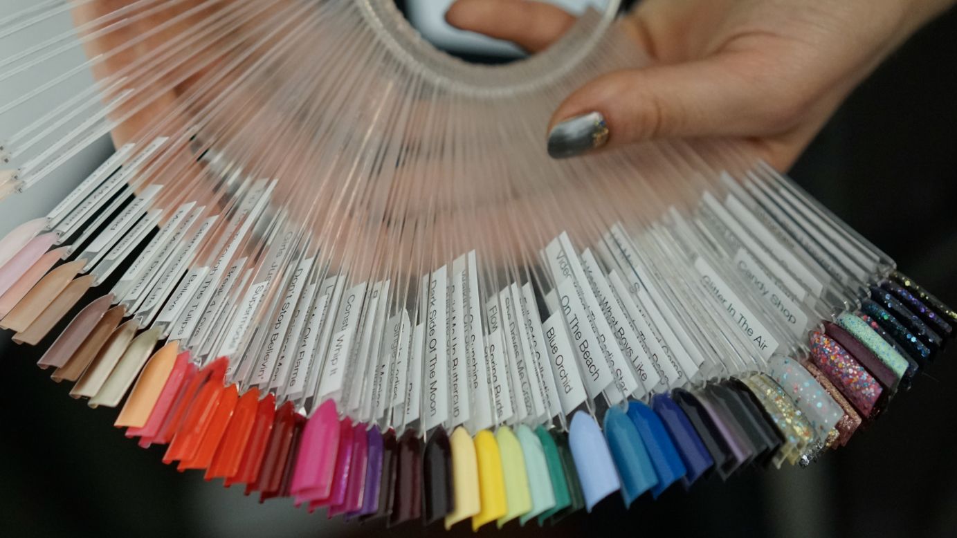 A nail artist shows off swatches of different polish colors before the Badgley Mischka show.