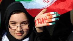 An Iranian student holds up her hand painted in the colors of her national flag during a rally in Tehran's Azadi Square to mark the 35th anniversary of the Islamic revolution on February 11, 2014.