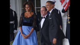 President Barack Obama and first lady Michelle Obama pose with French President Francois Hollande as he arrives for the state dinner at the North Portico of the White House  in Washington, DC.