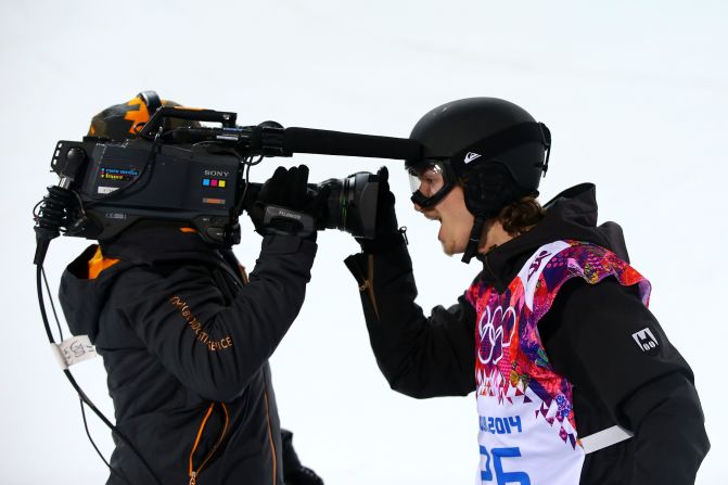 Snowboarder Iouri Podladtchikov of Switzerland celebrates in front of a TV camera after competing in the men's halfpipe on February 11.