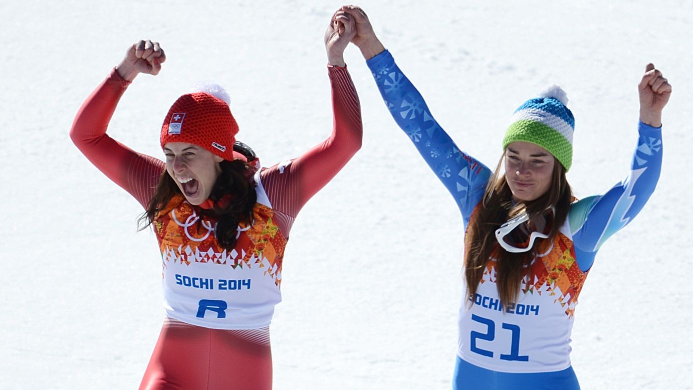 Dominique Gisin of Switzerland, left, and Tina Maze of Slovenia stand on the podium together after tying for the gold medal in the women's downhill February 12. The two skiers both finished their run with a time of 1:41.57.