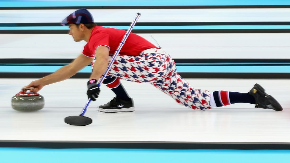 Thomas Ulsrud of Norway slides with the curling stone during a match against Germany on February 12.