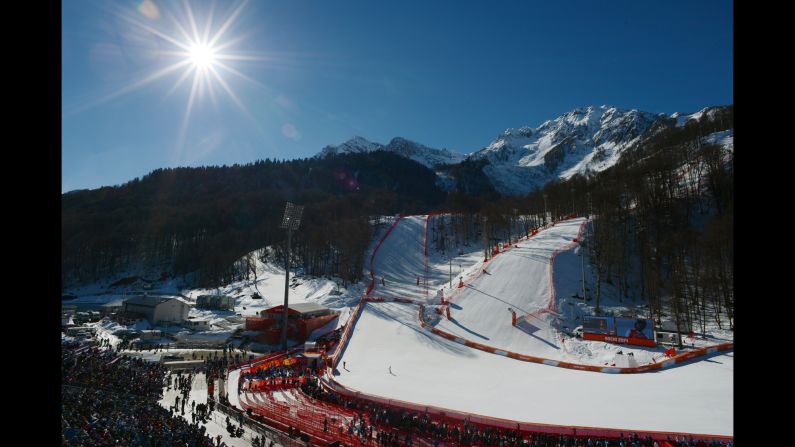 Skiers slide toward the finish line of the women's downhill event February 12.