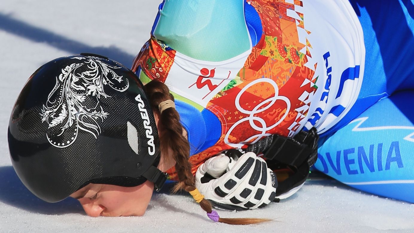Slovenian skier Tina Maze kisses the ground after her downhill run on February 12.