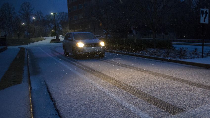 A motorist drives on a snow-and-ice-covered street in Johns Creek, Georgia, on February 12.