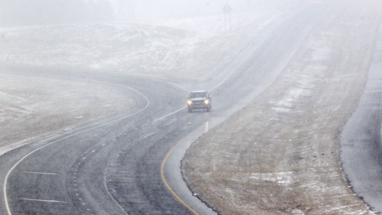 A vehicle drives through falling snow on the U.S. 421 bypass in Sanford, North Carolina, on February 11.