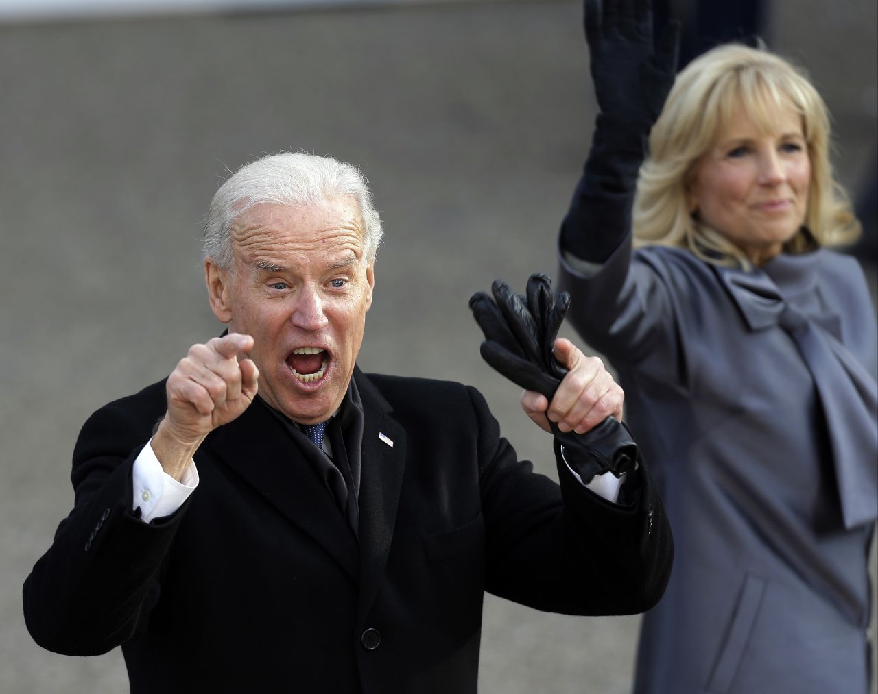 Joe Biden, with wife Jill, reacts to the crowd as they walk down Pennsylvania Avenue during the 2013 inaugural parade.