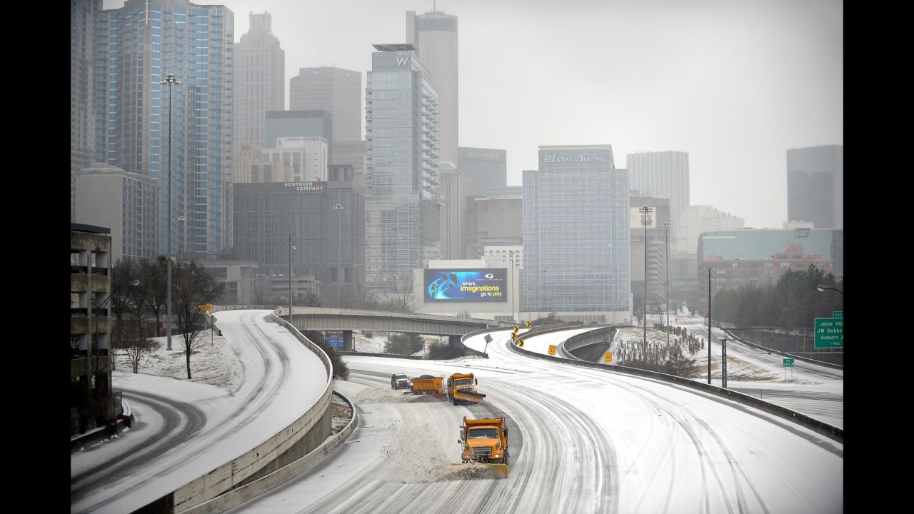 Snowplows clear Interstate 75/85 in downtown Atlanta on February 12.