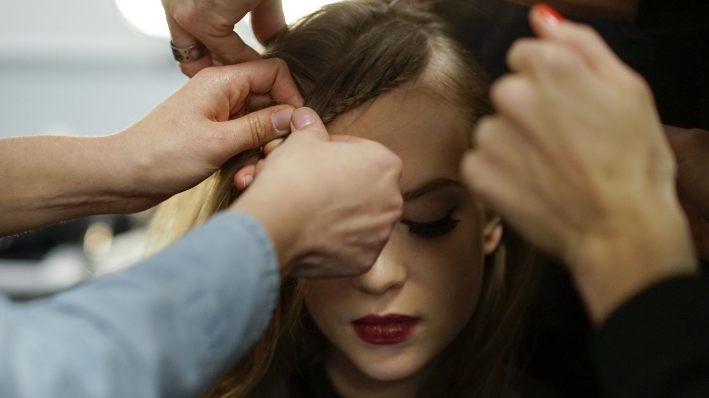 A model gets her hair styled before Nanette Lepore's show.