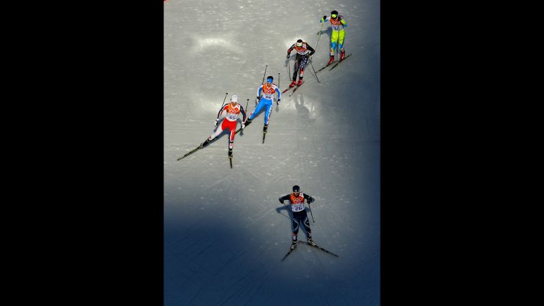 Eetu Vaehaesoeyrinki of Finland leads a group of skiers during the men's Nordic combined on February 12.