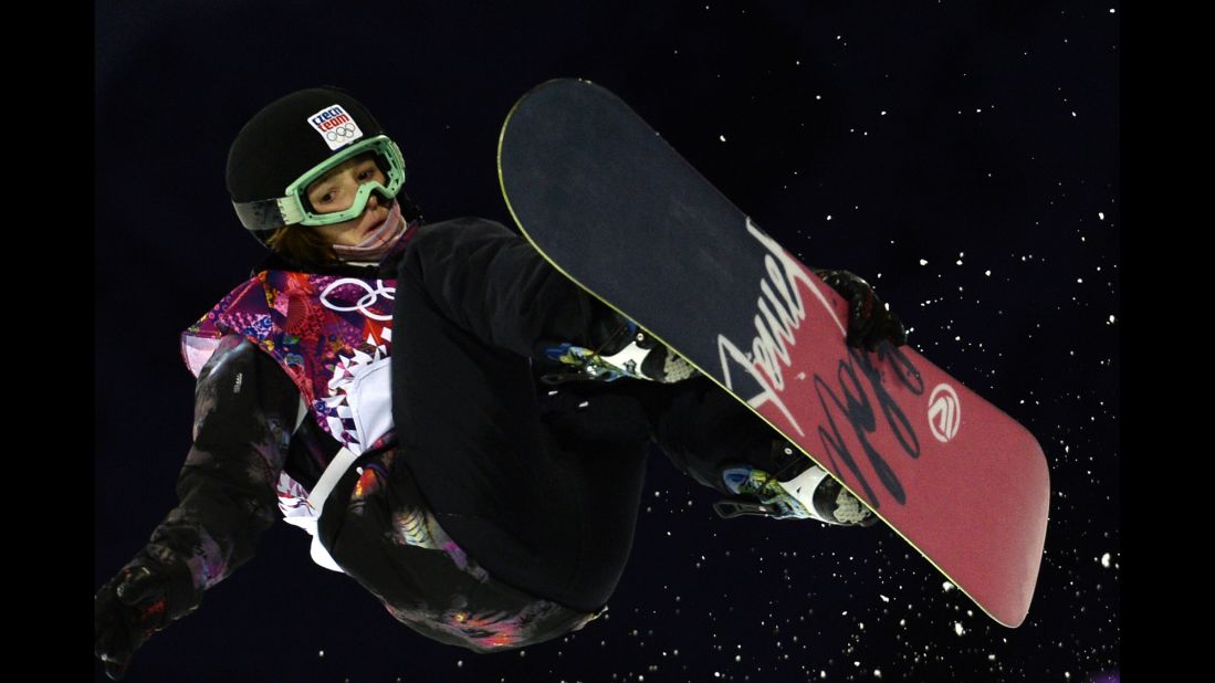 Sarka Pancochova of the Czech Republic grabs her snowboard in the halfpipe event February 12.