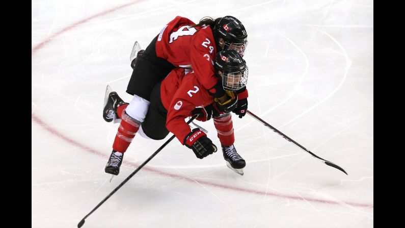 Canadians Natalie Spooner, top, and Meghan Agosta-Marciano celebrate Spooner's third-period goal against the United States on February 12.