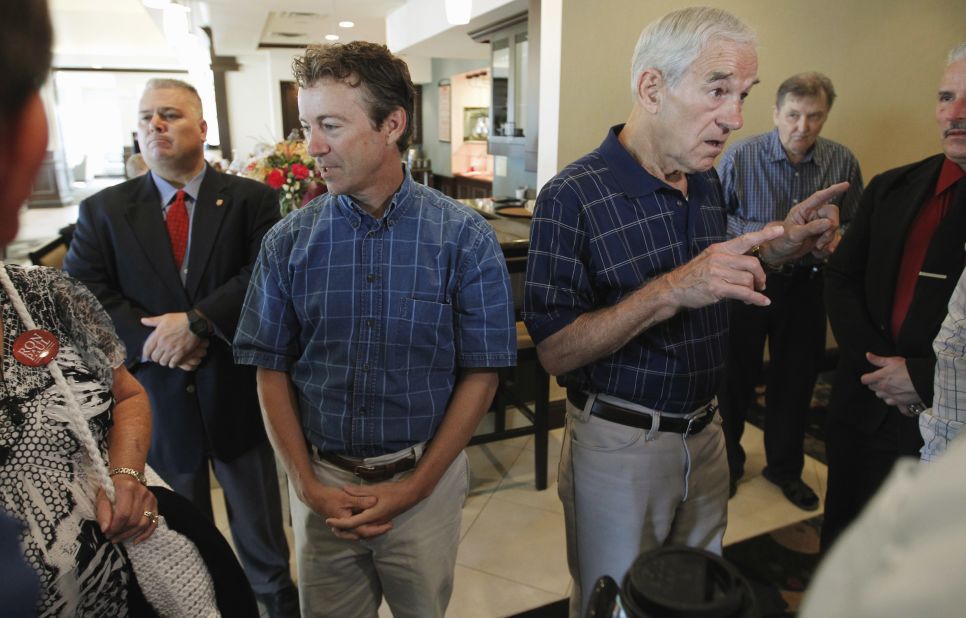 Paul and his father speak with supporters in Ames, Iowa, before the start of a 2012 presidential campaign event.