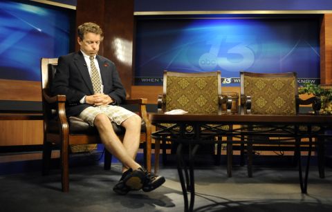 Coming from his son's soccer game, Paul wears shorts and a suit jacket while preparing for his guest spot on a Fox News television program in May 2010.