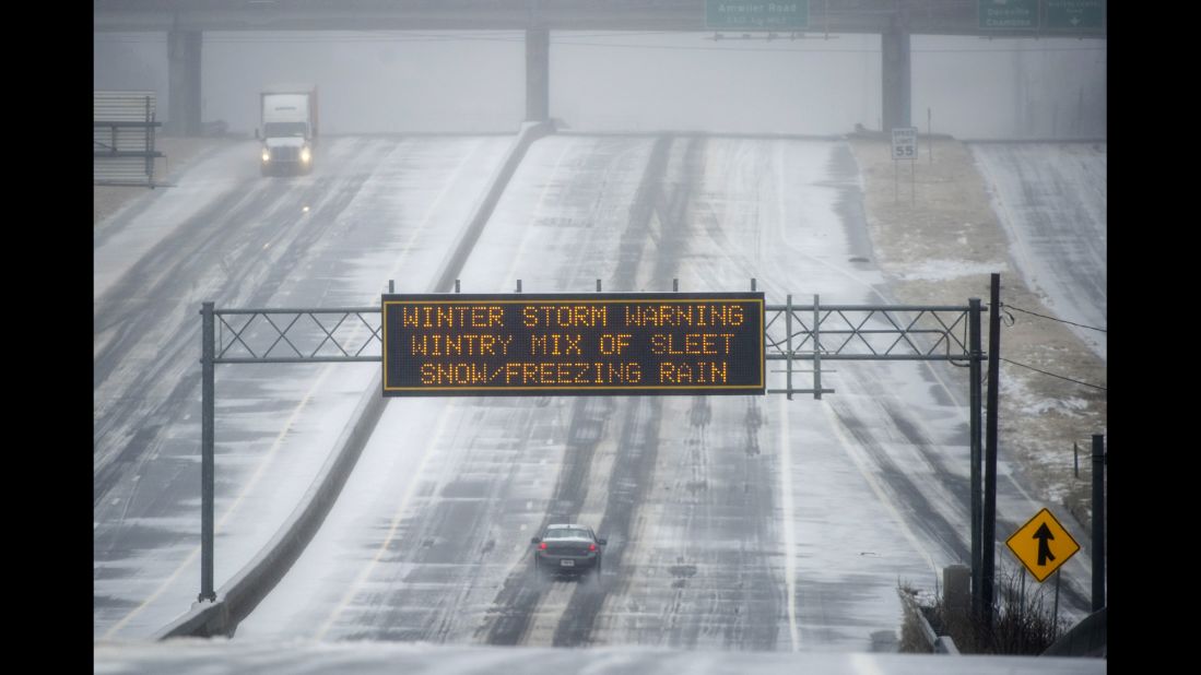 A sign warns drivers of winter weather as they travel on a bleak section of Highway 141 in Norcross, Georgia, on February 12.