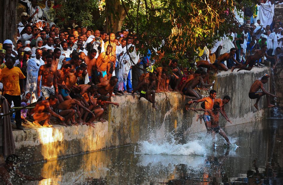 Once the water has been blessed, there is a race to jump in. Some participants even dive in from nearby trees. 