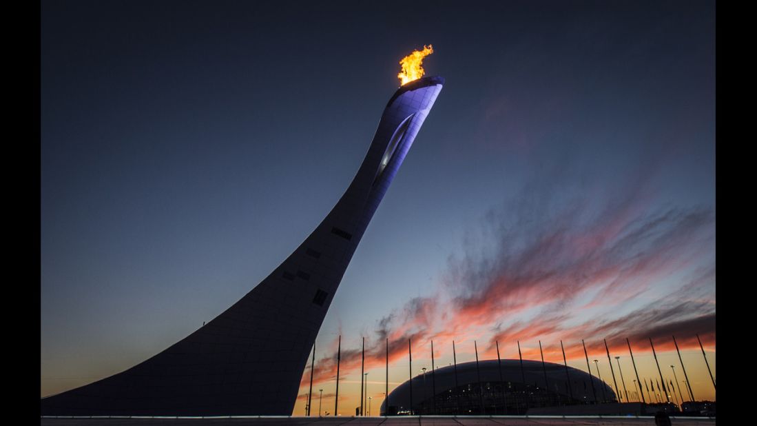 The Olympic cauldron blazes in front of the Bolshoy Ice Dome at sunset February 12.